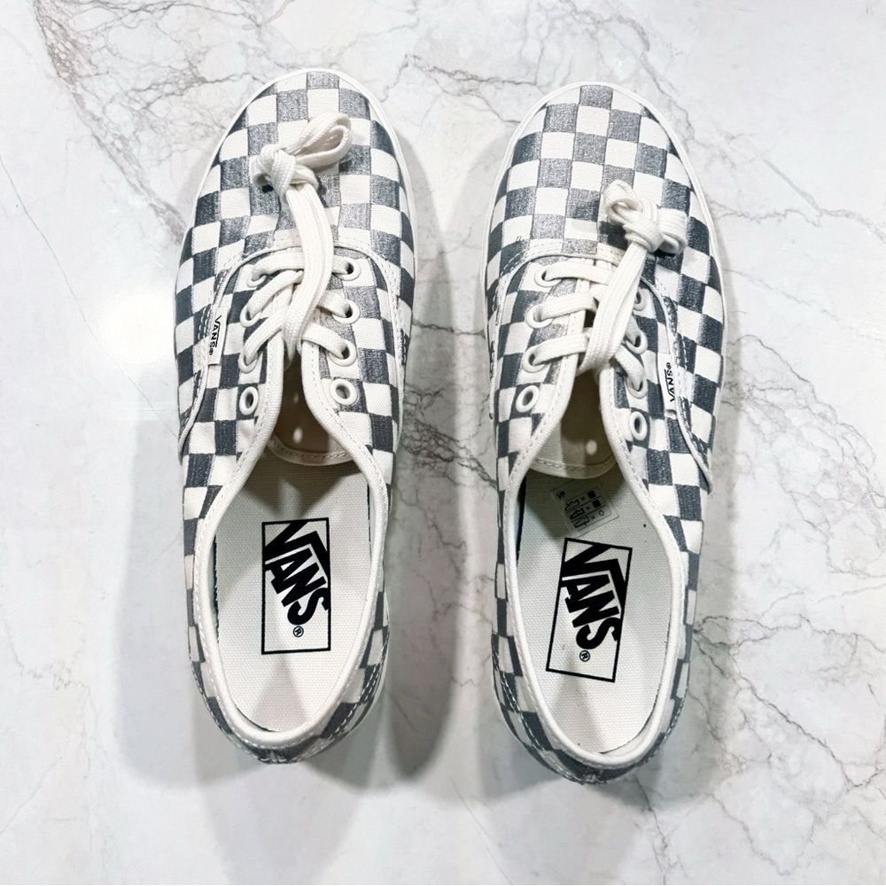 Classic Vans checkerboard platform sneakers in white and gray metallic.